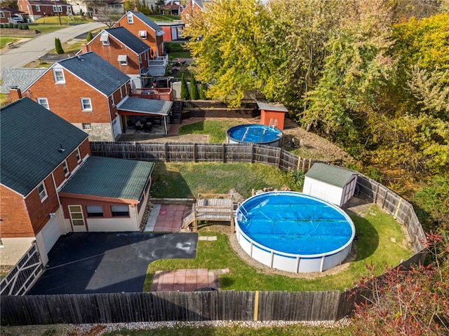 view of swimming pool featuring a shed