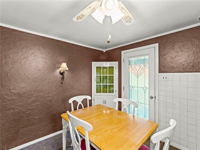 dining space featuring ceiling fan and crown molding