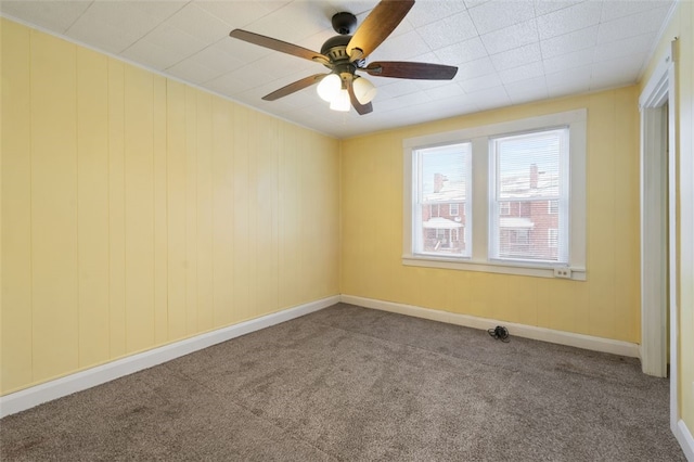 spare room with ceiling fan and carpet