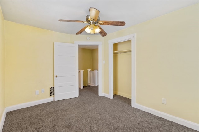 unfurnished bedroom with ceiling fan, carpet, and a closet