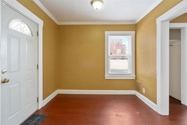 entryway with dark hardwood / wood-style flooring and crown molding