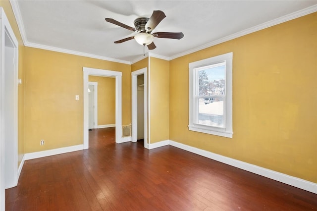 unfurnished room featuring ceiling fan, dark wood-type flooring, and crown molding