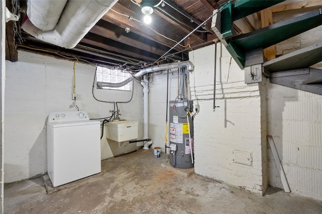 basement with water heater and washer / dryer