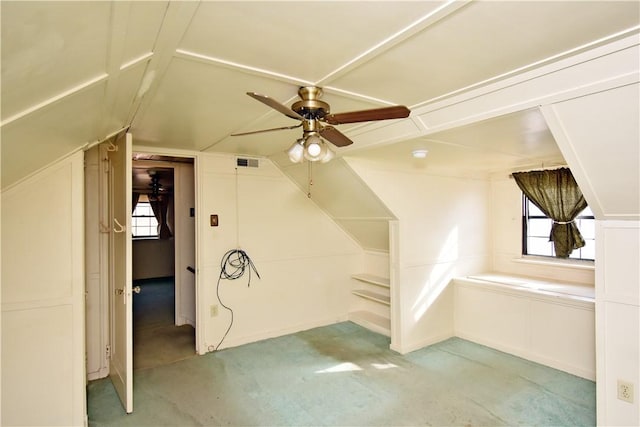 additional living space with vaulted ceiling, ceiling fan, and light colored carpet