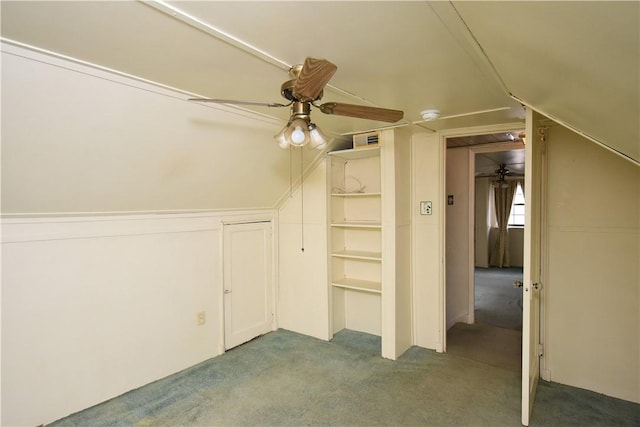 bonus room featuring light carpet, ceiling fan, built in features, and lofted ceiling