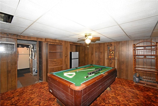 game room with ceiling fan, billiards, a paneled ceiling, and wooden walls