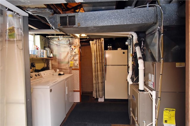 interior space with white fridge, separate washer and dryer, and heating unit