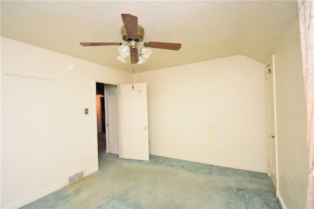 carpeted empty room featuring a textured ceiling and ceiling fan