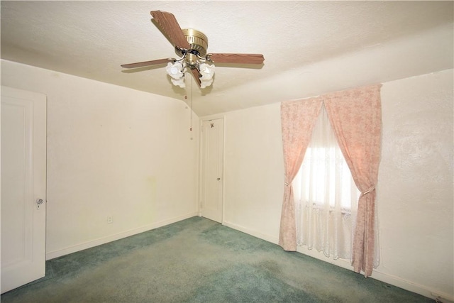 carpeted spare room with a textured ceiling and ceiling fan