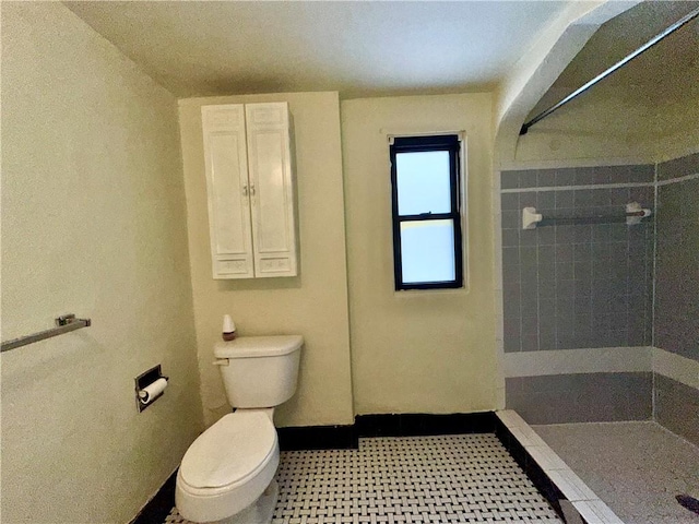 bathroom with toilet and a shower