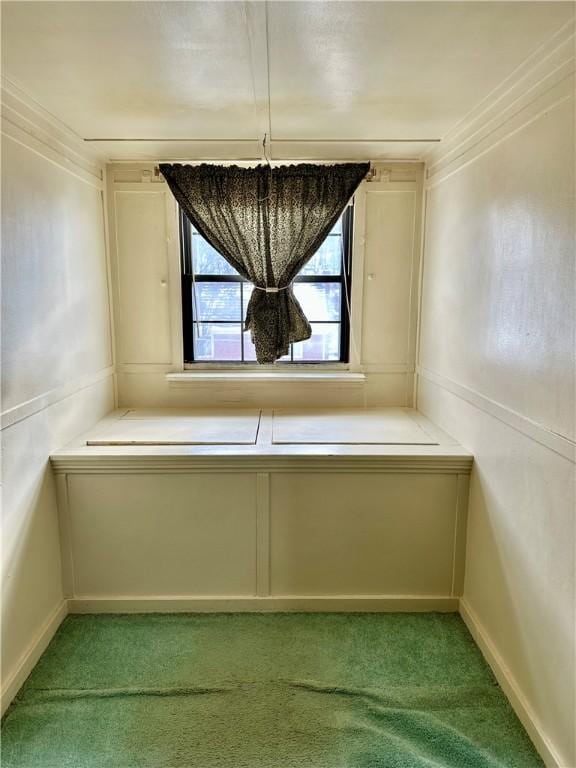 interior space featuring crown molding and light carpet