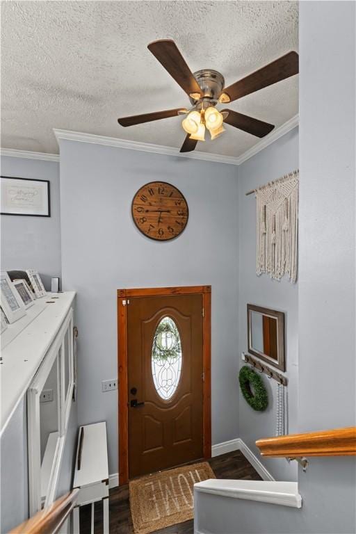 foyer featuring ceiling fan, a textured ceiling, dark hardwood / wood-style floors, and crown molding