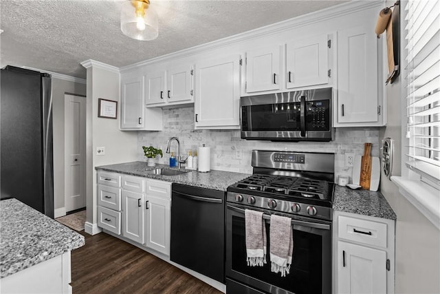 kitchen with white cabinets, sink, crown molding, and stainless steel appliances