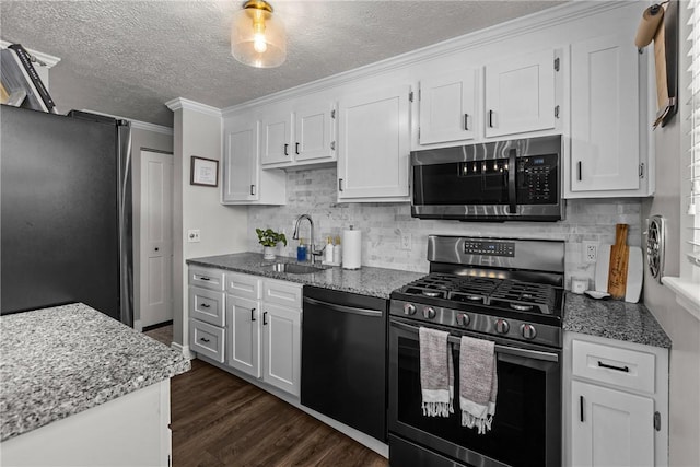 kitchen featuring sink, white cabinetry, appliances with stainless steel finishes, and a textured ceiling