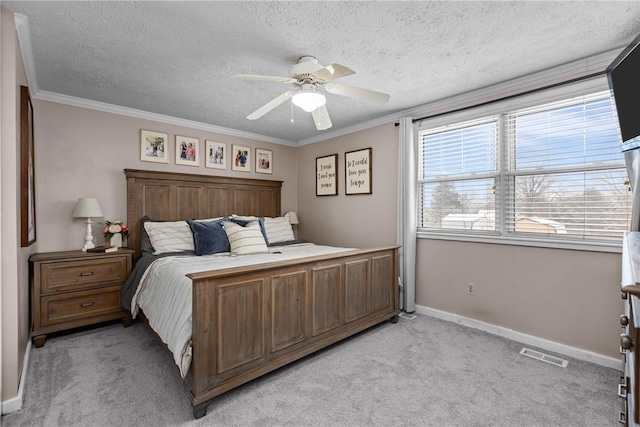 carpeted bedroom with ceiling fan, a textured ceiling, and ornamental molding