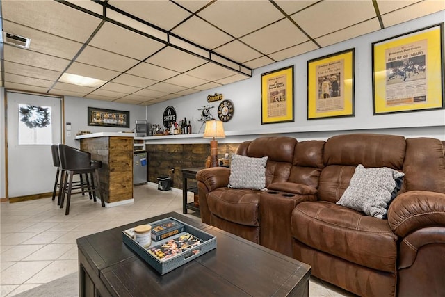 living room with light tile patterned floors and indoor bar