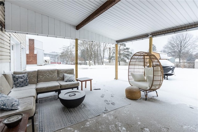 snow covered patio featuring outdoor lounge area