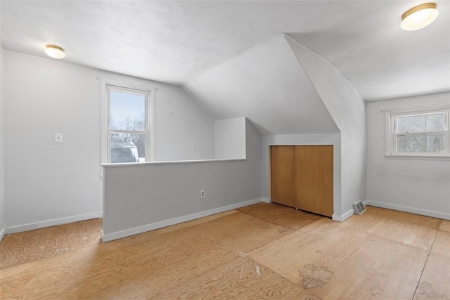 bonus room with vaulted ceiling and plenty of natural light