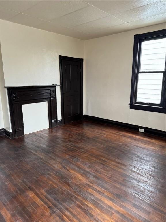 unfurnished living room with dark hardwood / wood-style floors