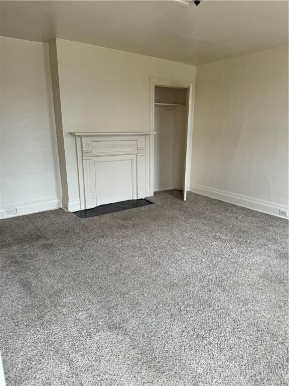 unfurnished bedroom featuring a closet and carpet