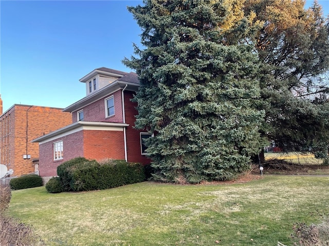 view of side of home featuring a yard