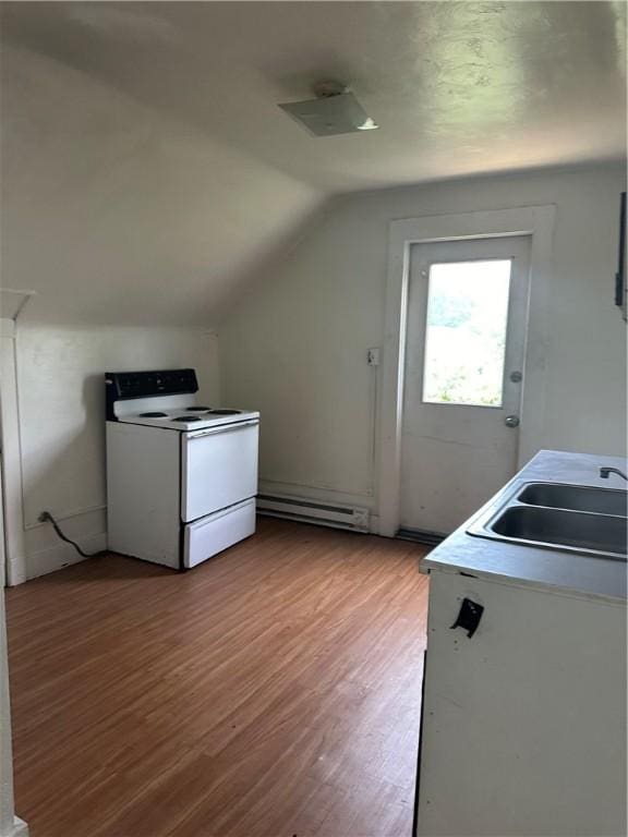 interior space with a baseboard heating unit, light wood-type flooring, and sink