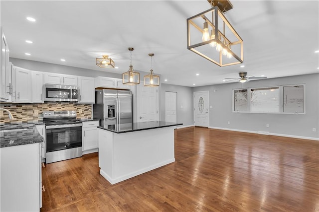 kitchen with white cabinetry, pendant lighting, and stainless steel appliances