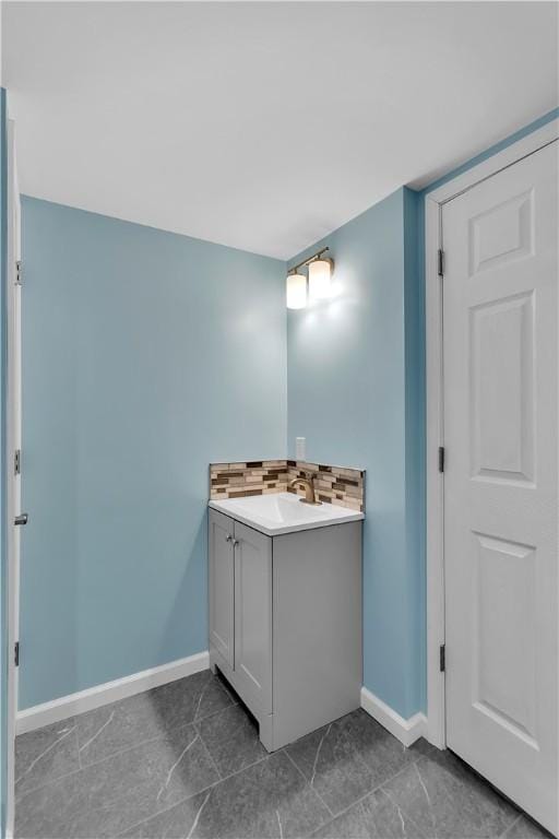 bathroom with tasteful backsplash and vanity