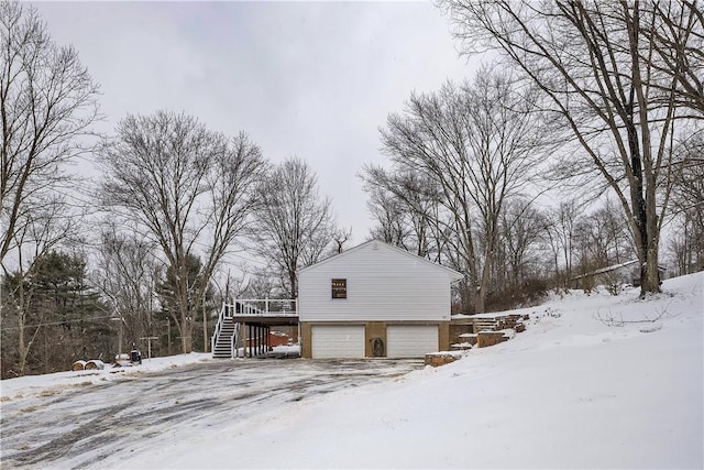 view of snowy exterior with a garage