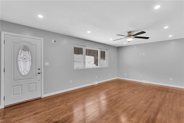 foyer with ceiling fan and wood-type flooring