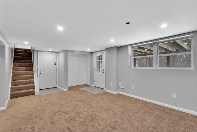 basement featuring light colored carpet