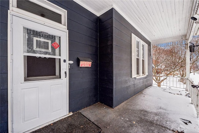 view of snow covered property entrance