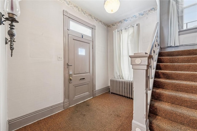 foyer with carpet and radiator heating unit