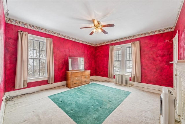 miscellaneous room featuring ceiling fan, light colored carpet, a high end fireplace, and radiator