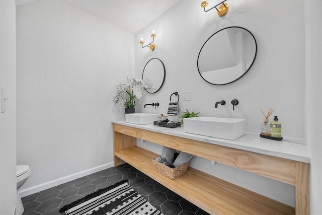 bathroom with tile patterned floors, vanity, and toilet