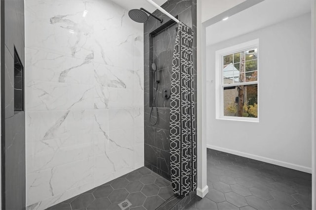 bathroom with tile patterned floors and tiled shower