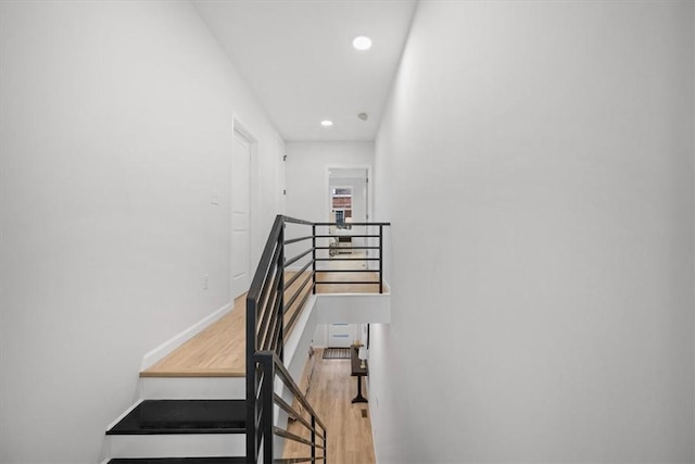 stairway with hardwood / wood-style flooring