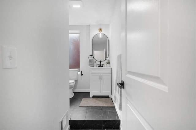 bathroom featuring toilet, vanity, and tile patterned flooring