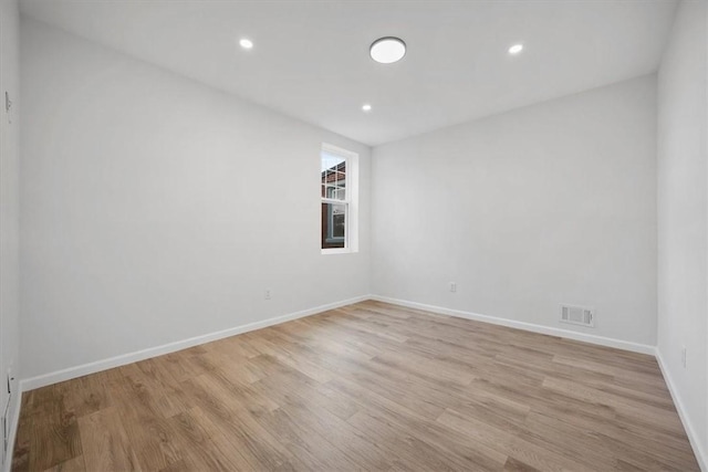 spare room featuring light hardwood / wood-style flooring