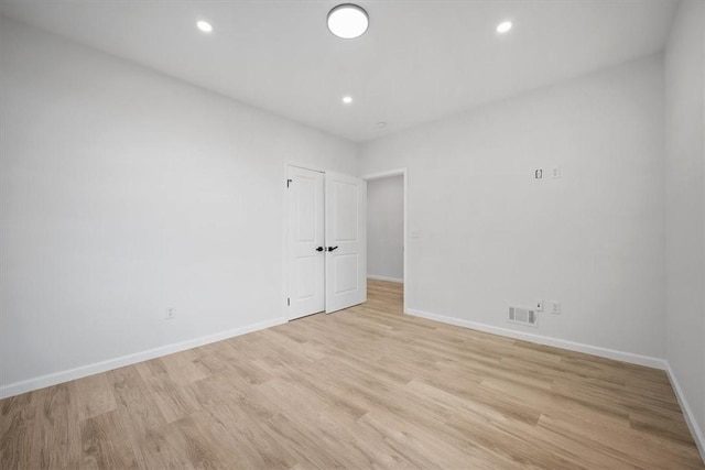 empty room with light hardwood / wood-style floors