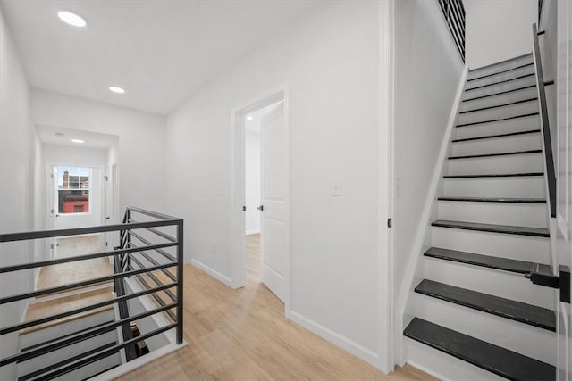 staircase with hardwood / wood-style floors