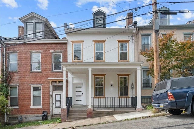 townhome / multi-family property with a porch