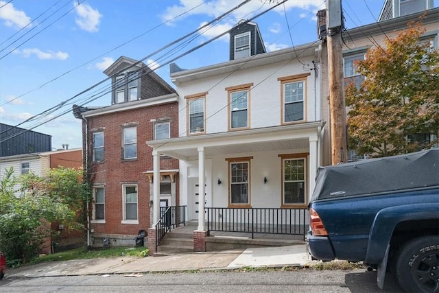 townhome / multi-family property with a porch