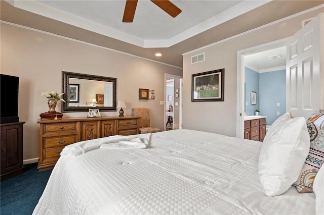 bedroom with ensuite bathroom, ceiling fan, crown molding, and dark colored carpet