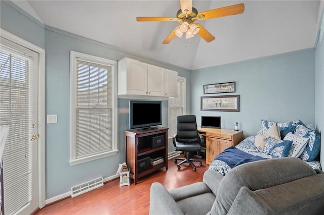 home office with vaulted ceiling, ceiling fan, ornamental molding, and hardwood / wood-style floors