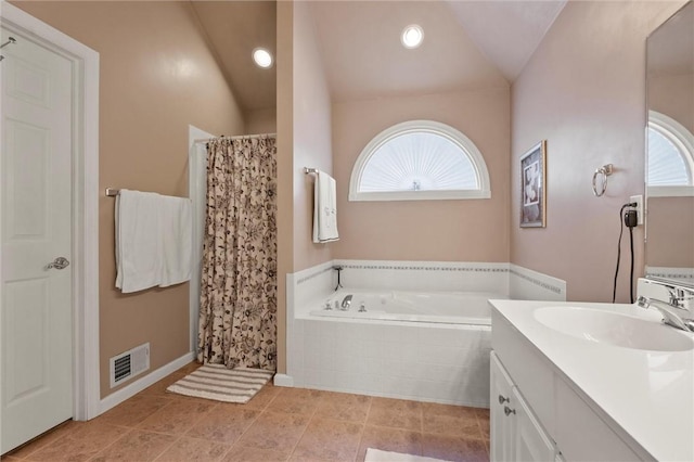 bathroom with vanity, vaulted ceiling, and independent shower and bath