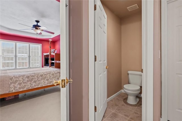 bathroom with toilet and ceiling fan