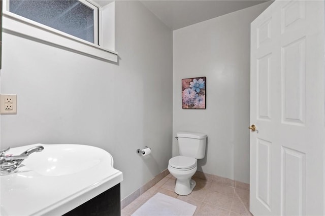 bathroom with tile patterned floors, vanity, and toilet