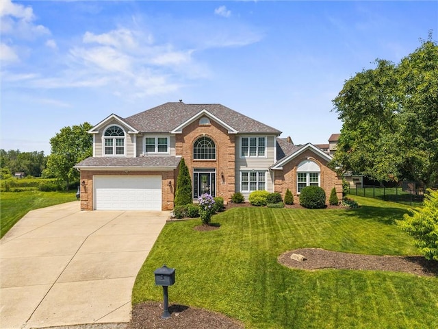 1004 Deveron Ct, Jeannette, PA 15644 - traditional-style house with driveway, a garage, brick siding, and a shingled roof