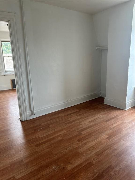 unfurnished room with hardwood / wood-style flooring